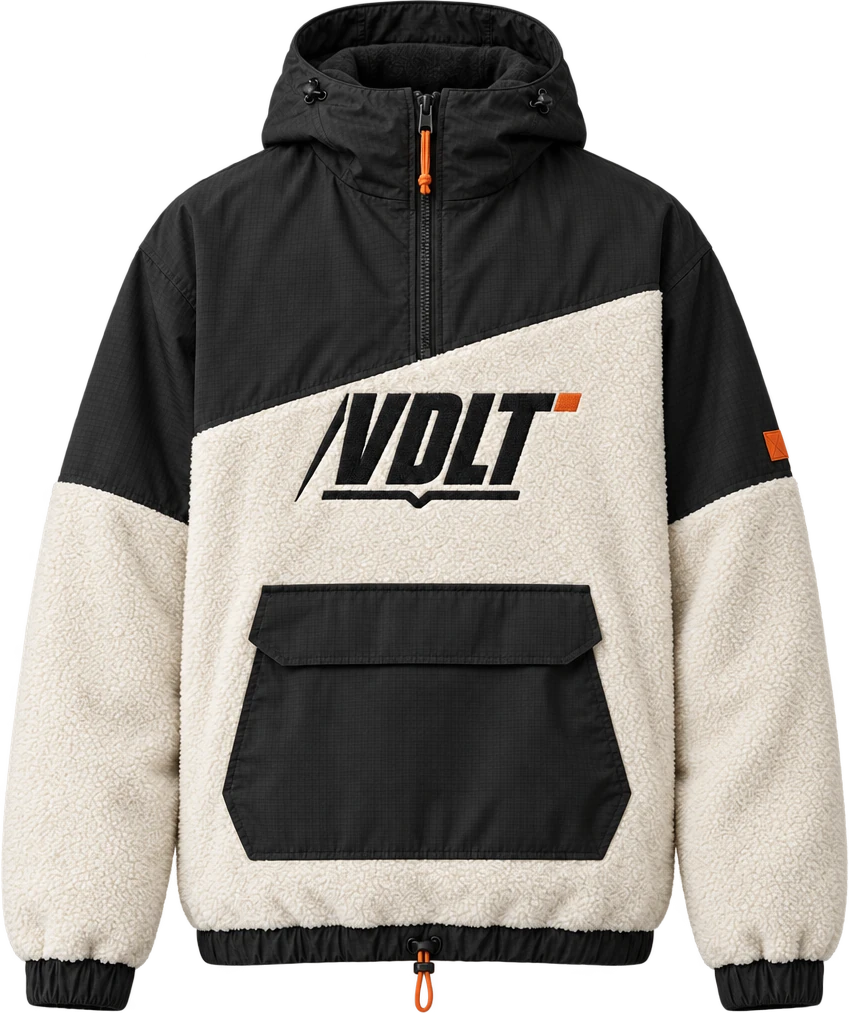 Anorak Cresta de VDLT: tejido técnico negro en capucha y hombros, borreguillo color hueso en el cuerpo y logo bordado en el pecho